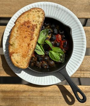 Olives, tomatoes, basil, wine, lemon, garlic, and pepper bruschetta at Veganika in Ljubljana