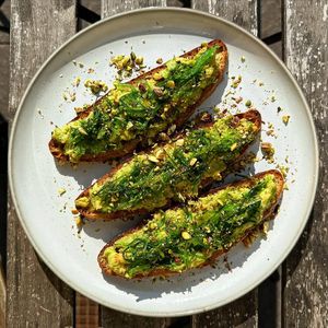 Avocado on bread with wakame, pistachios, and sunshine at Veganika in Ljubljana