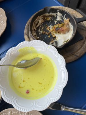 Lemon soup (must try!) and part of the bread dumplings with garlic sauce and chimichuri (also insane)  at Veganika in Ljubljana