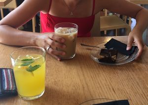 The lemonade in the forground and the brownie and ice coffee further back. at Veganika in Ljubljana
