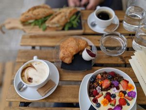 Latte, granola, croissant, tofu sandwhich at Veganika in Ljubljana