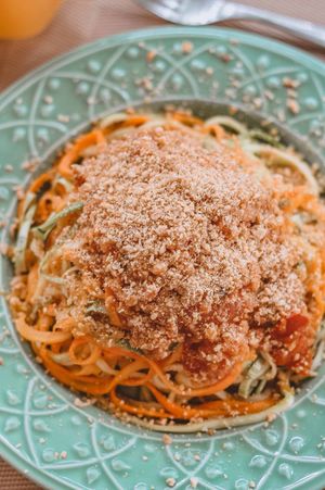 Carriot and zucchini spaghetti al dente with pink lentil bolognese and cashew parmesan. at Tita Bistro in Rio De Janeiro