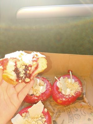 Vegan raspberry + rhubarb 24-hour yeast raised donut layered with crushed sugar cookie streusal, raspberry rhubarb jam, raspberry glaze, and dollops of raspberry vegan buttacream,  at The Salty Donut in Miami