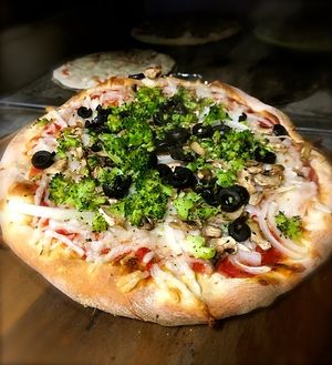 Large pizza w/ onion, broccoli, black olive, fresh cut mushroom, and vegan mozzarella.  at Sibie's Pizza in Amherst