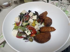 Red lentil patty with fresh Greek salad and tofu  at Flow Specialty Coffee Bar & Bistro in Budapest
