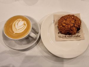 Cappuccino and almond cookie at Flow Specialty Coffee Bar & Bistro in Budapest