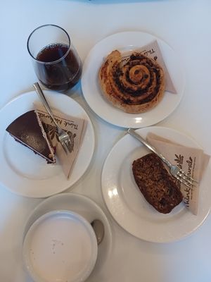 Chai latte with oat milk, single brew, black forest cake, banana bread, chocolate swirl at Flow Specialty Coffee Bar & Bistro in Budapest