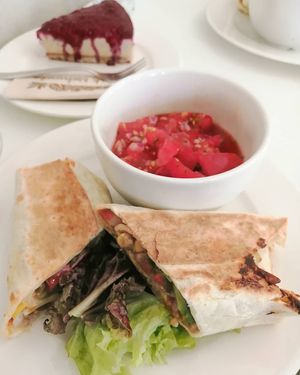 Tortilla with fresh tomato salsa, raspberry cheesecake. at Flow Specialty Coffee Bar & Bistro in Budapest