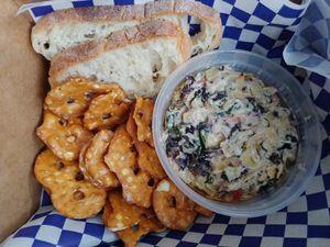 $5.95 Vegan Artichoke Dip with baguette slices and pretzel chips at One Grub Community in El Paso