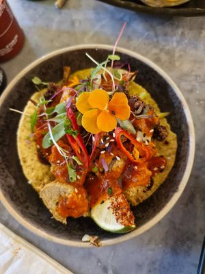 Vegan Taco: Plantbased crispy chickaan, aromatic cauliflower, corn tortilla, holy guacamole, picked carrot, apple & mango slaw, coriander, chilli oil, tamarind, & red pepper sauce at Viet Shack in Manchester