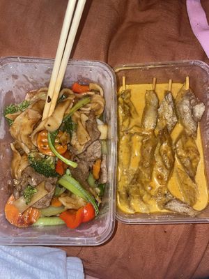 Veggie beef fried noodles (half eaten) and chicken satay skewers  at Tian Ci Vegan in Darlington