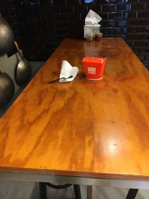 The (lone) table at Wok to Walk; there are stools for sitting, plus container with food. at Wok to Walk in New York City