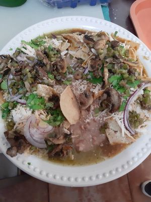 Chilaquiles divorciados morita/verdes con champiñones y nopales at Panza Llena Corazón Contento in San Jose Del Cabo