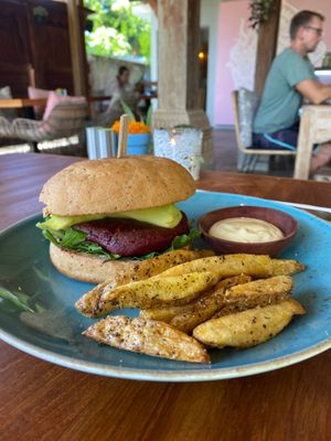 Buddha burger.  Beetroot and chickpea burger patty, sliced avocado & rocket.  Served with handcut fries and veganese.   at Kayu Lembongan in Lembongan