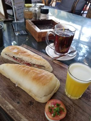 The Artjuna breakfast with oriental sandwich without egg, pineapple juice, and lemongrass tea. at Artjuna in Anjuna