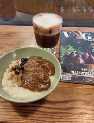 A breakfast porridge (with date jam and blackcurrants, so good!!!), a hot chocolate and a vegan magazine   at VegB12 in Tallinn