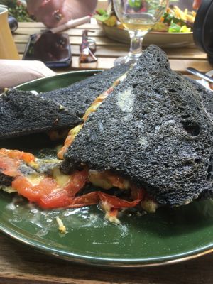 Charcoal bread cheese,tomato and pesto toastie  at Plantarium Cafe in Stratford-upon-avon