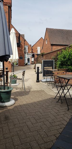 some of the courtyard! you are underneath a clocktower and there are just a few tables and umbrellas , really special. at Plantarium Cafe in Stratford-upon-avon
