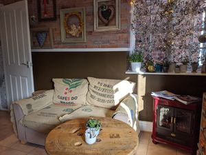 interior ground floor, with cozy stove at Plantarium Cafe in Stratford-upon-avon