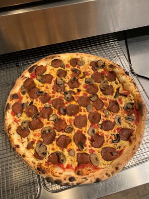 Naturally leavened sourdough crust with tomato sauce, house made cashew mozzarella, East Village PDX vegan roni and roasted mushrooms at Scottie's Pizza Parlor in Portland