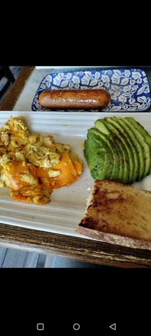 Vegan scrambled eggs with cheese, avocado, bread, and a side of sausage. at Filoncino Cafe in Staten Island