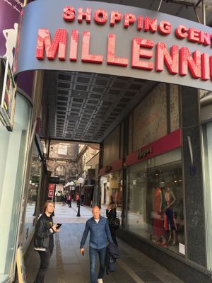 The sign you should look for is red, on the right side of Kneza Mihaila Street as you are headed to Republic Square. As of April '19 it was next to a ladies clothing store. at Veganski Kiosk in Belgrade