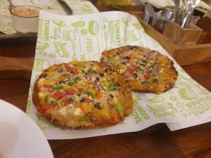 Pizzas? 4/10 these I didn't enjoy with the dough being like crumbly crackers and the toppings being overloaded with minced veg at Step Out Cafe in Jaipur