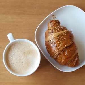 Oat milk latte and croissant at Limau in South West London