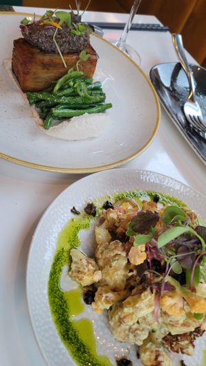 Cauliflower bites (bottom), potato mille feuille (top) at Bistro Tendresse in Montreal