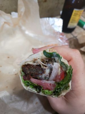 Falafel wrap with lettuce, tomato, onion and the housemade hot sauce. at Jerusalem Market on Elm in Greensboro