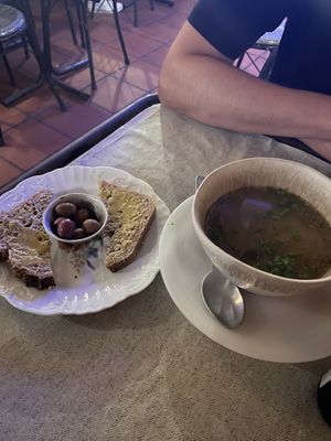 Bread with tahini and olives on the side (left), vegetable soup (right)   at Casa da Horta in Porto