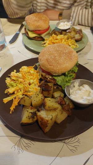 Cheeseburgers with bean patty, baked potatoes w/vegan mayo and coleslaw. All vegan at Casa da Horta in Porto