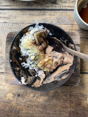 Smoothie bowl — based blended with bananas, dates, peanut butter and cacao; toppped with pineapple, coconut flakes, crush almonds, and chia seeds.   at Flowers & Fire in 