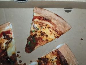 One bite of toppings on a slice. at Crust Gourmet Pizza Bar in Richmond