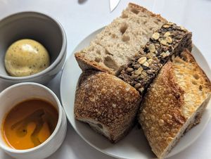 Bread service with miso butter and gazpacho soup at FREA in Berlin