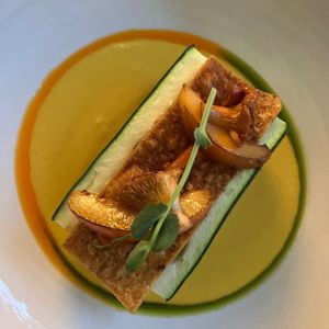 Zucchini: Sweet potato tamales, chanterelles, yellow chili, apricot, corn chips, and marigold at FREA in Berlin