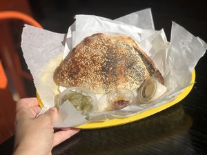 Mushroom, potatoes and onions pastry served with tahini, chili oil, and pickles at Frena Bakery and Café - Richmond in San Francisco