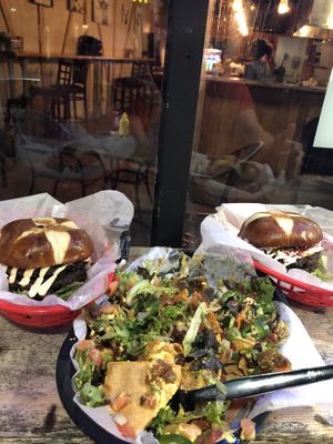 From left to right- Thee evolve smash burger, nachos (partially devoured) and the crack burger at Evolve Modern Vegan Kitchen in Daytona Beach