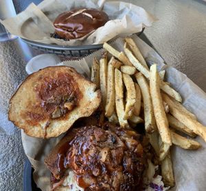 Foreground: dog with jackfruit bbq.  Note the soft pretzel bun in background.  Served with a crunchy, healthy slaw. at Evolve Modern Vegan Kitchen in Daytona Beach