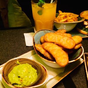 Fried pickles/gherkins/cucumbers...the little spiced ones you normally get on the hamburger😉with avocado-dip, fries and a mango-peppermint juice  at Hans im Glück  in Hagen