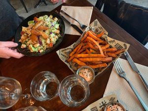 Caesar salad and potato fries at Mad Mad Vegan - Chueca in Madrid