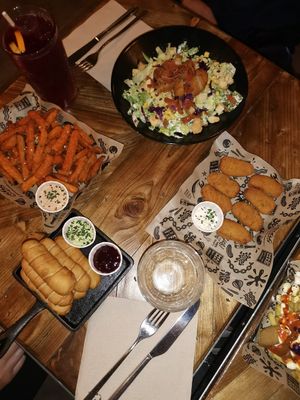 The vegan ceasar salad, sweet potato fries, v mozzarella sticks, chick*n pieces at Mad Mad Vegan - Chueca in Madrid