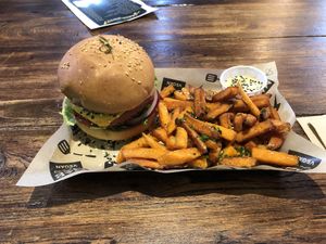 Signature MAD Burger with sweet potatoe fries! Best vegan burger I’ve tried so far in Europe!! at Mad Mad Vegan - Chueca in Madrid