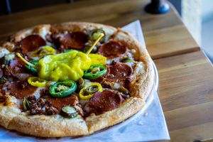 ***HOT AS HELL*** Your choice of 10" house made crust made with Non-GMO NEVER BLEACHED NEVER BROMATED flour, house spicy marinara, red chili peppers, house mozzarella blend, fresh  at Pythagoras Conscious Food Philosophy in Houston