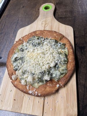 The Space Swamp! The dough was sweeter than expected, and the topping wasn’t quite like parmesan, though the spinach and saucy cheese were still nice.  at Pythagoras Conscious Food Philosophy in Houston