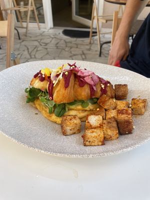 Egg and avocado croissant with smoked tofu side  at Kat's Kitchen Brunch Club in Split