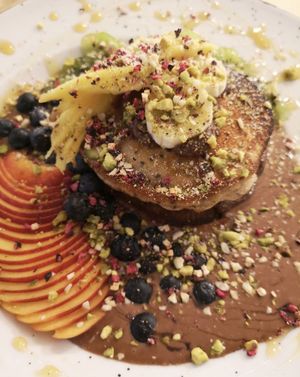 Vegan Spelt pancakes with homemade raw cocoa and hazelnut spread topped with warm cashew sauce and fresh organic fruits at Kat's Kitchen Brunch Club in Split