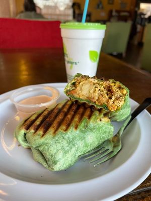 Vegan Treehugger Wrap- Tofu scramble, tots, spinach, sautéed peppers and onions, vegan breakfast sausage, vegan cheese, and tomatoes at Drunken Monkey Coffee Bar in Orlando