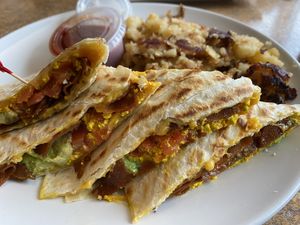 Vegan Morning Quesadilla.    Scrambled Tofu, Vegan Bacon, Fresh Avocado, Tomatoes & Vegan Cheese, served with Home Fries, Vegan Sour Cream & Salsa  at Colony Diner in Wallingford