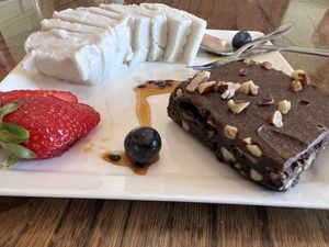 Melt in your mouth carob chocolateyyyy brownie with what tasted like caramelised pecans/walnuts inside. Perfection paired with the ice cream!!!  at Mary-Ann's Natural Emporium in Cape Town